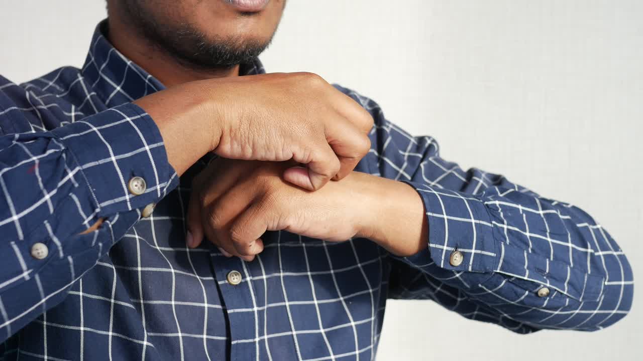 Man scratching his arm