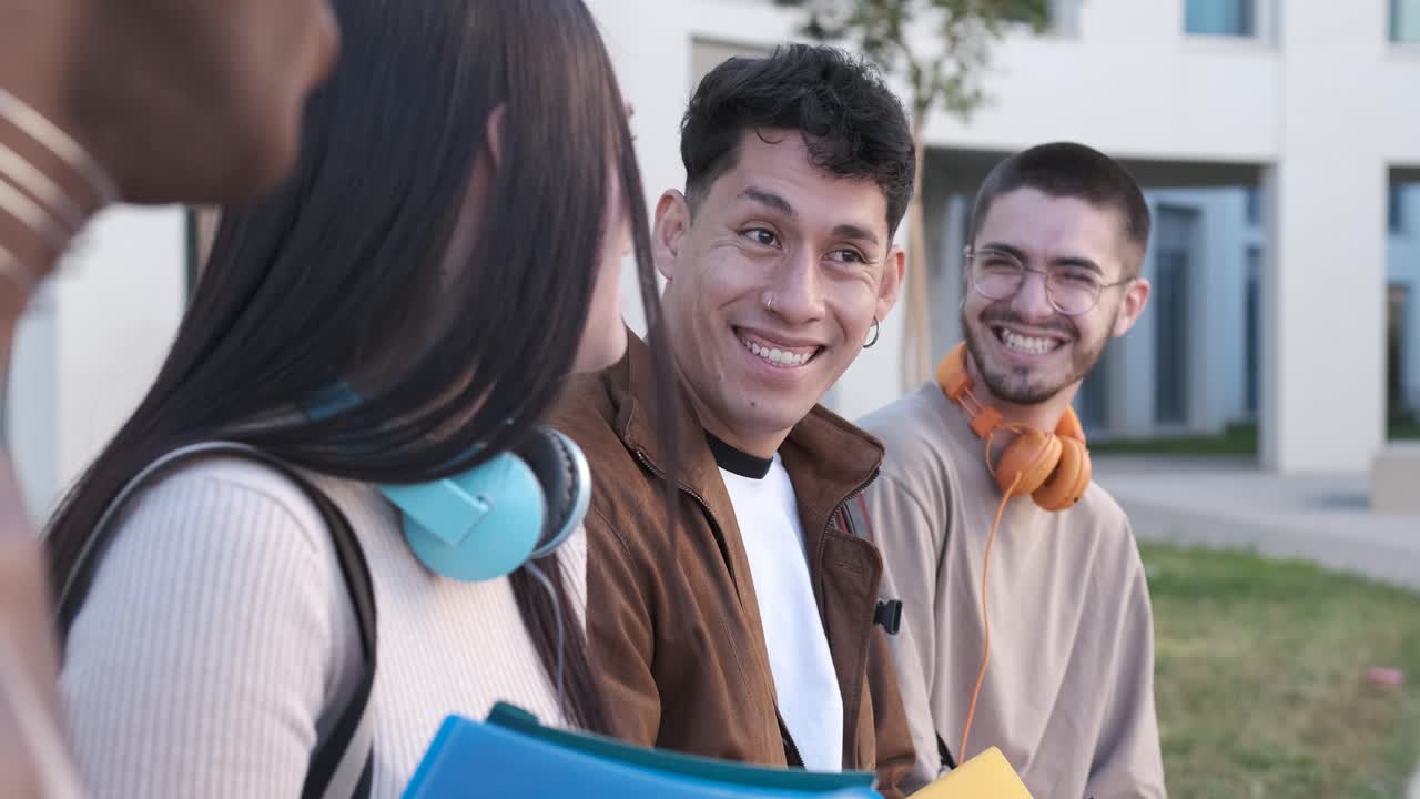 Group of friends smiling and chatting sitting outdoors
