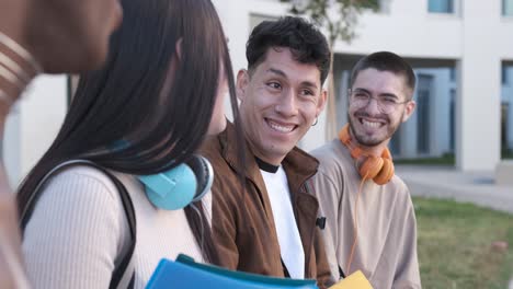 Group of friends smiling and chatting sitting outdoors