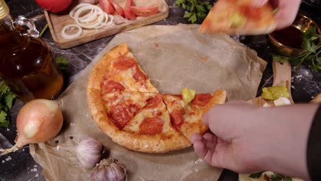 people takes from table slices of fresh italian pizza.