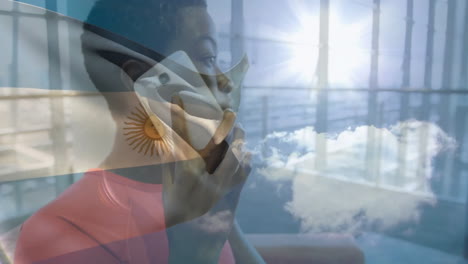 Talking on phone with Argentina flag and sky animation overlay, person smiling