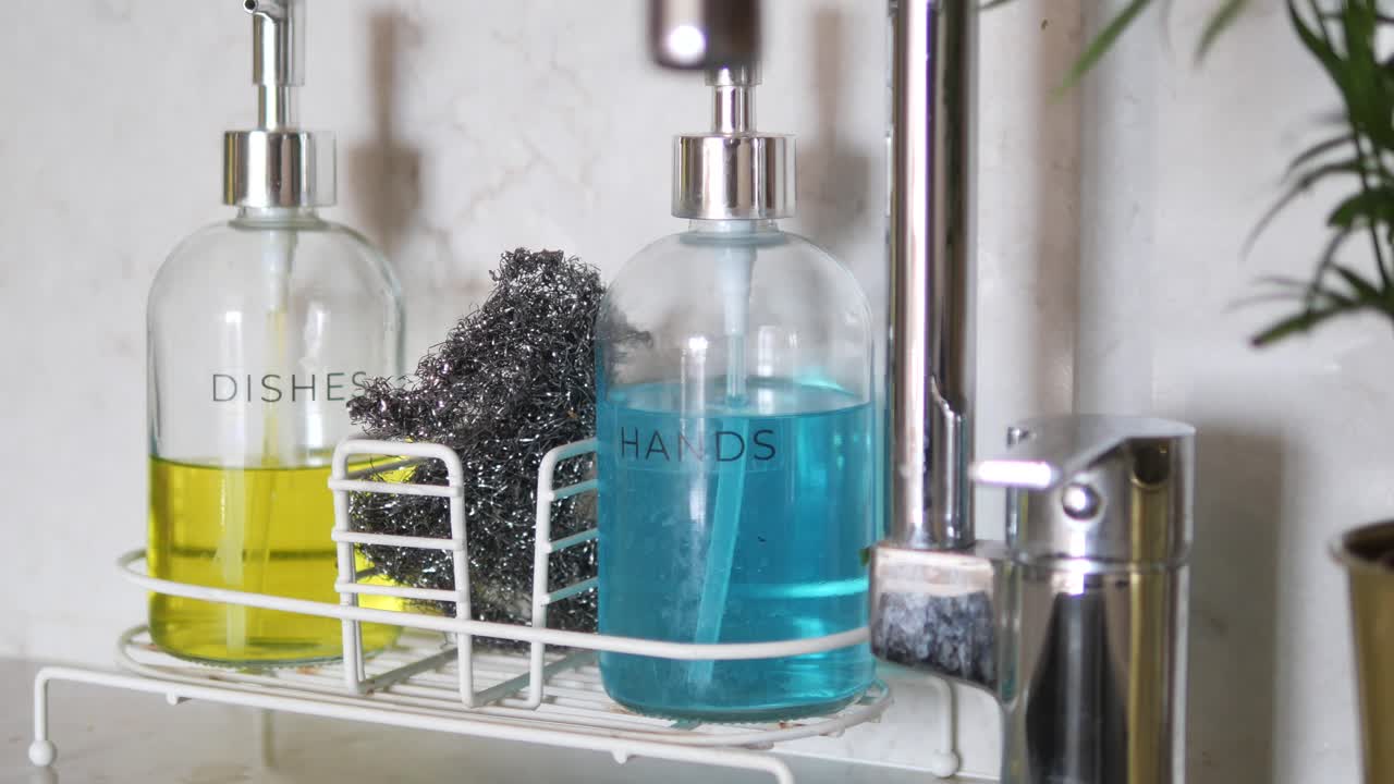 Soap Dispensers and Cleaning Supplies by the Kitchen Sink