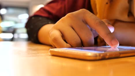 woman using a mobile phone in a cafe