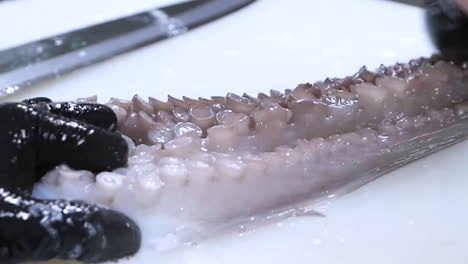 a chef cleans octopus. raw seafood