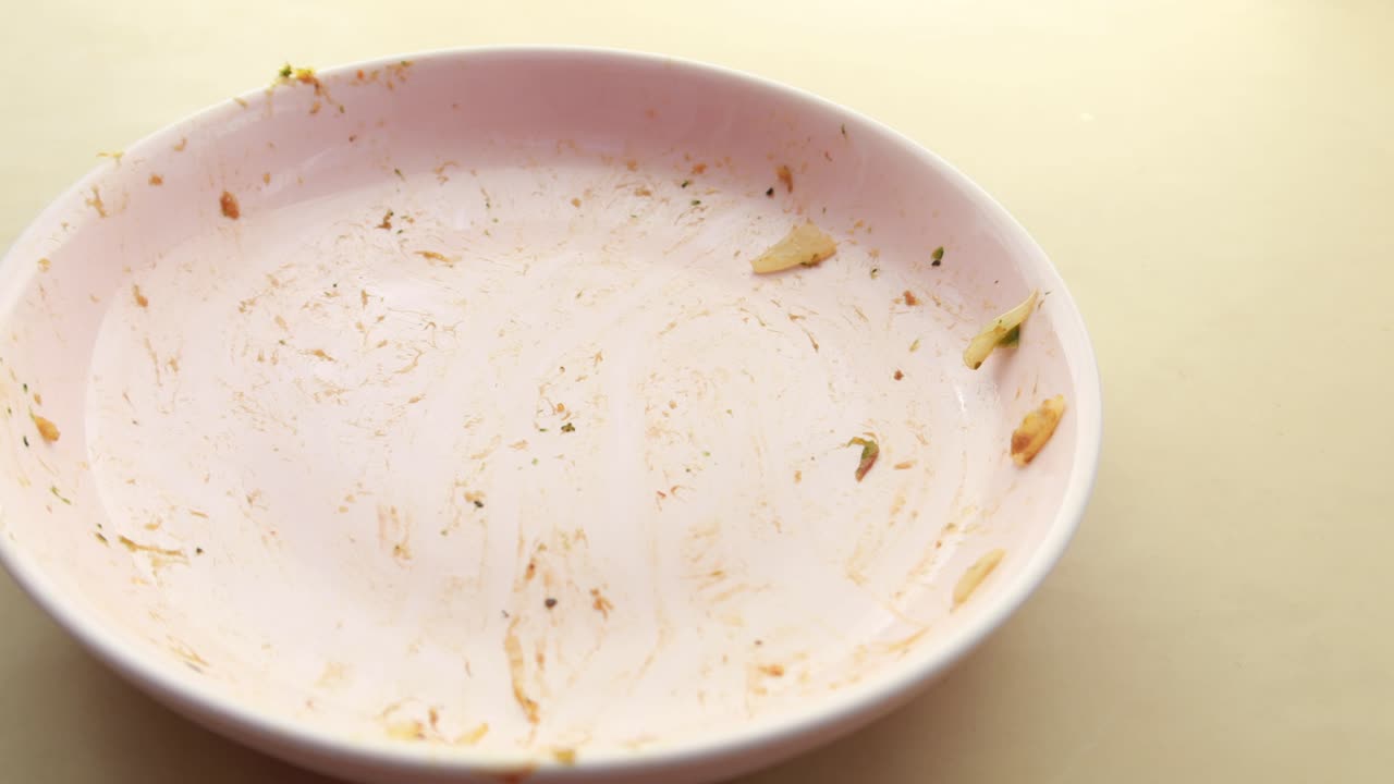 Empty Pink Plate with Food Remains