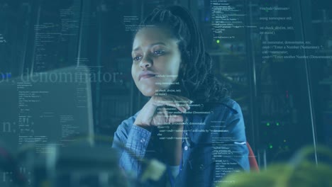 Animation-of-data-processing-against-african-american-female-engineer-using-laptop-at-server-room