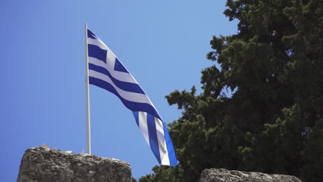 grecian national flag waving in strong wind on beautiful summer day