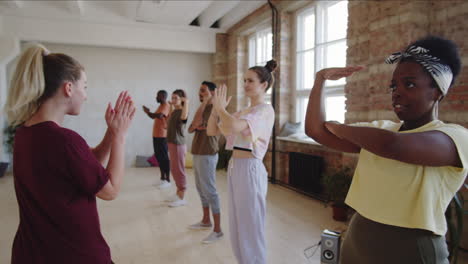 dance teacher working with group of multiethnic students