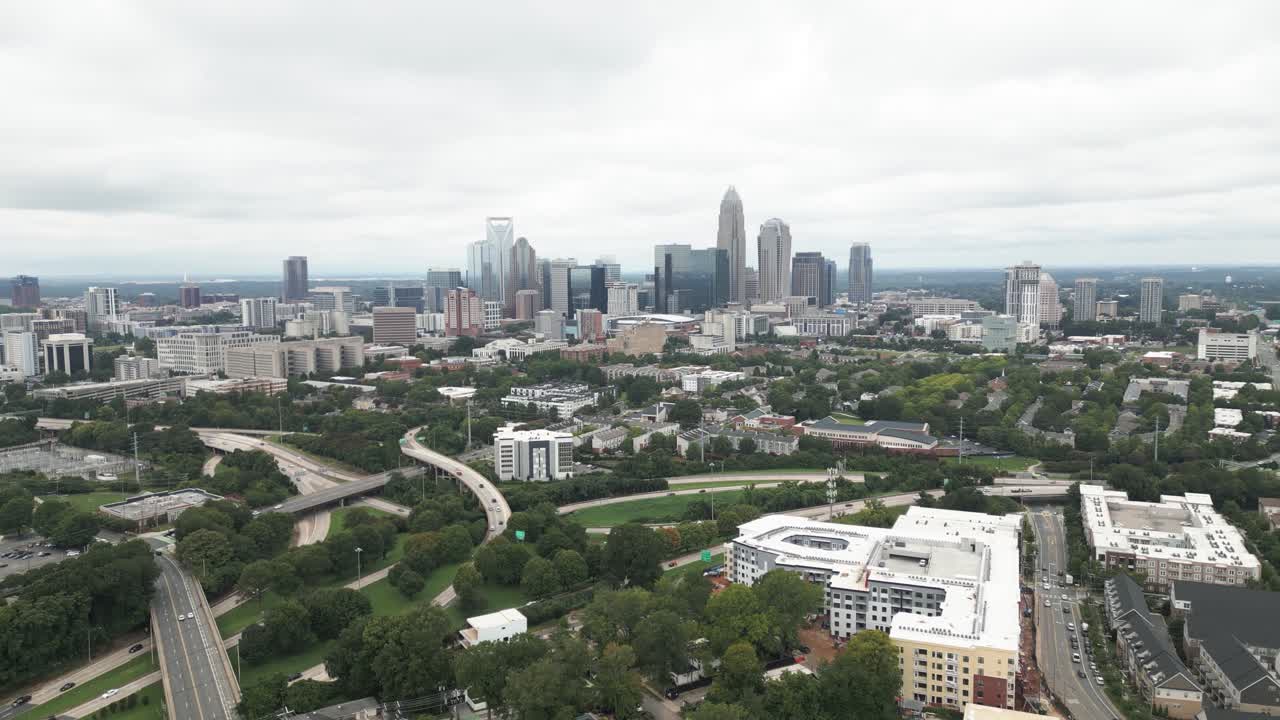 Charlotte skyline is revealed when drone tilts up on a cloudy day