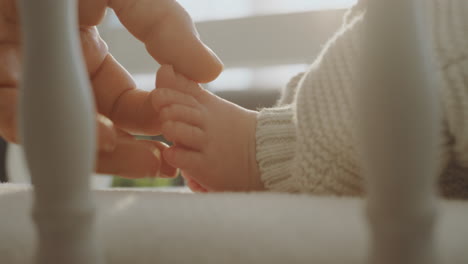 parent holding baby's foot