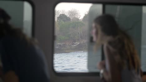 woman looking out boat window