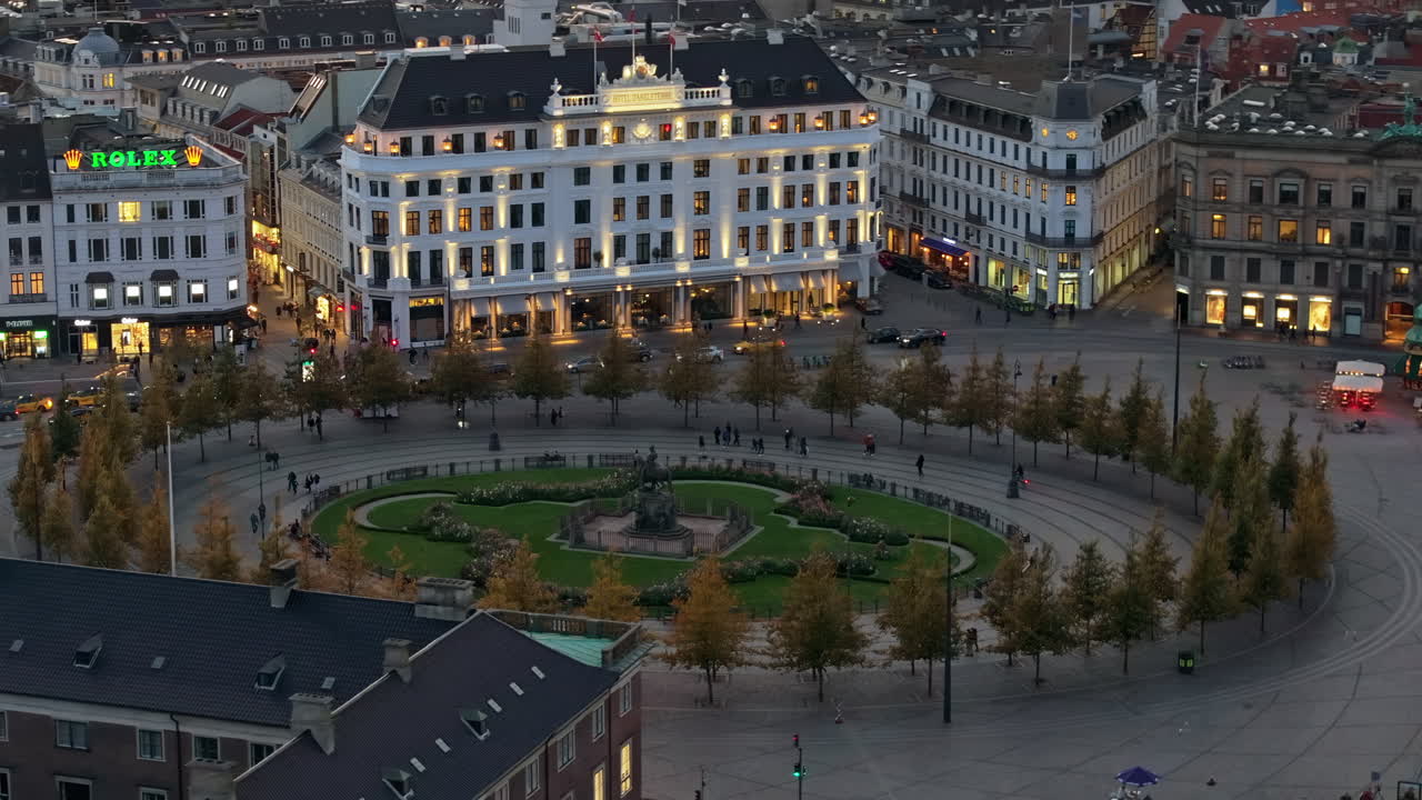 Aerial drone view of the Kongens Nytorv public square in Copenhagen, Denmark at night