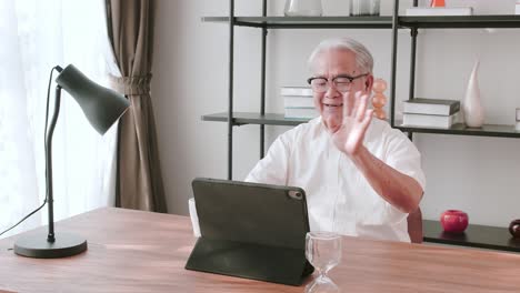 Middle-aged-male-chatting-via-video-link-with-longtime-friends