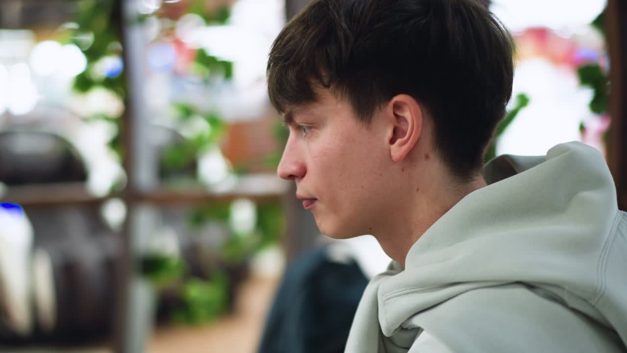Close up of European looking boy neck and ear showing reddish dot marks on skin while camera captures detail with soft blur background and subtle light highlighting texture and beauty of enviroment