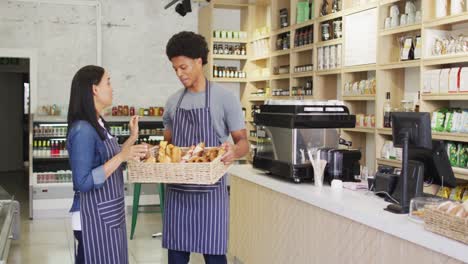 Animation-of-happy-diverse-female-and-male-waiters-with-bread-talking-in-coffee-shop