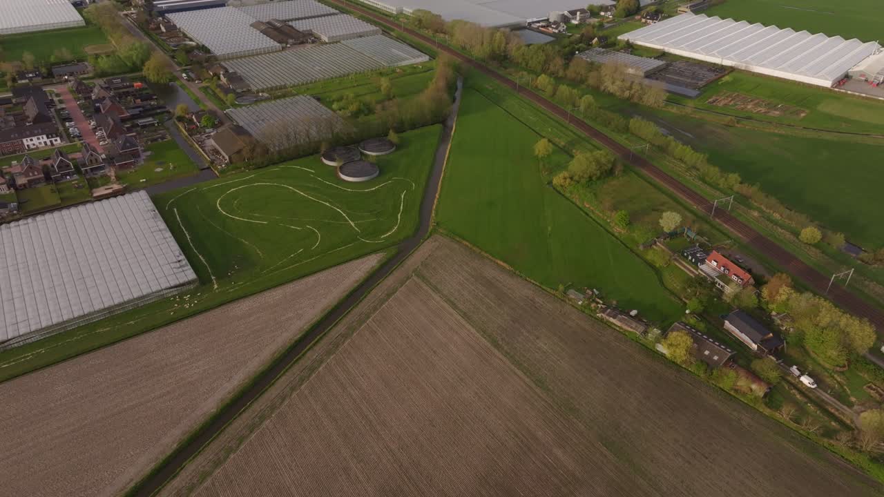 Rail and greenhouse network amid fields in Heerhugowaard, Netherlands