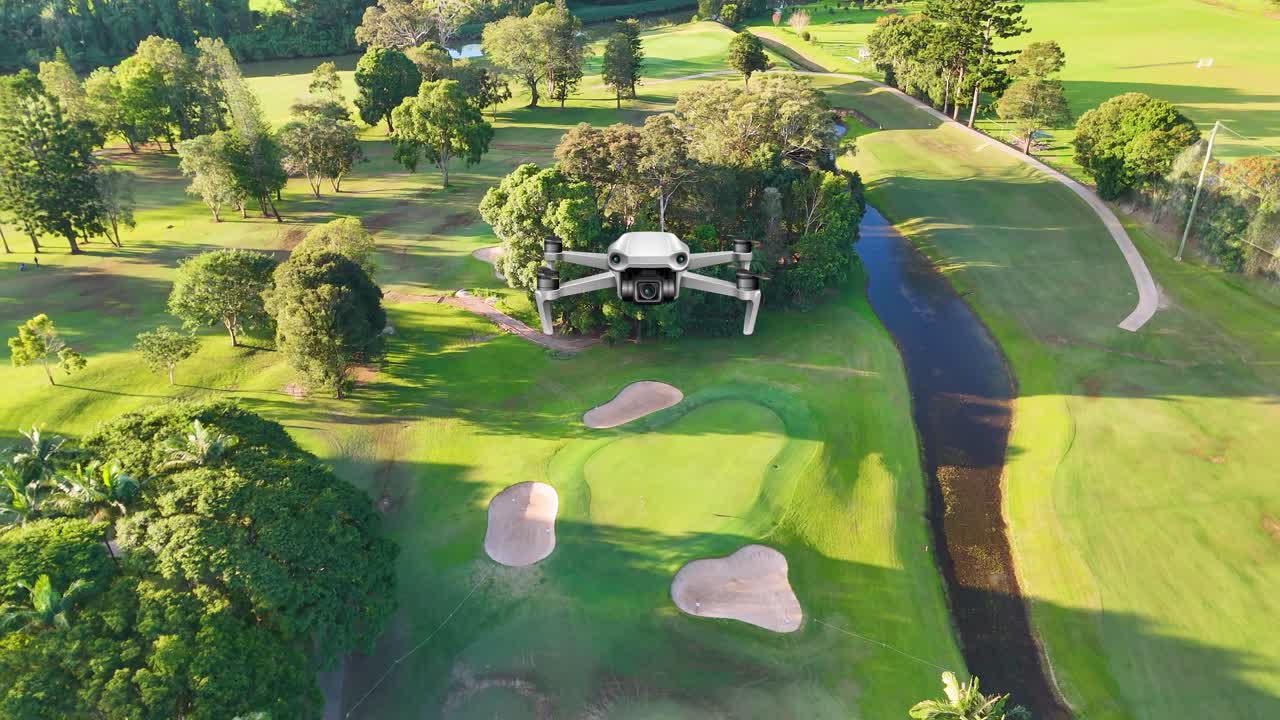 Aerial animation of a lush golf course with vibrant greenery and winding paths under bright sunlight