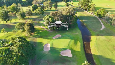aerial animation of a lush golf course with vibrant greenery and winding paths under bright sunlight