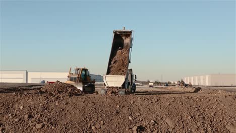 bulldozer and dump truck moving earth at a construction site