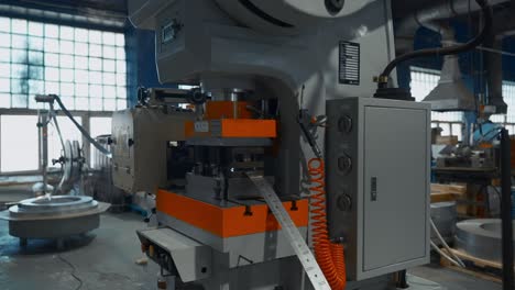 metal press machine in a factory setting