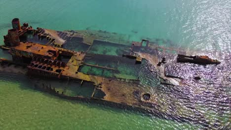 4k tilt up clip over a shipwreck in the tropical beach of epanomi, norhtern greece