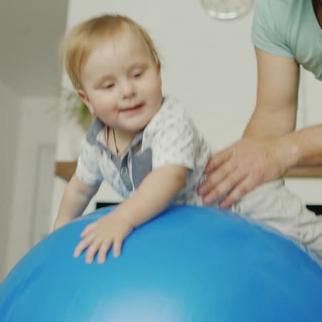 dad plays with his young son at home