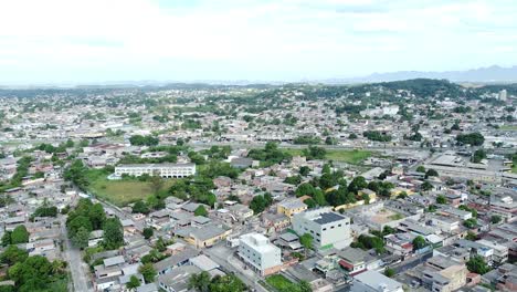 Aerial-shot-of-Rio-de-Janeiro-at-Duque-de-Caxias-showing-houses-and-favelas