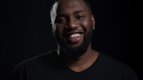 Cheerful-afro-guy-posing-indoors.-African-man-staring-at-lens-in-studio