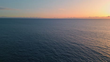 aerial view yacht sailing to sunset horizon. evening sundown reflecting at ocean