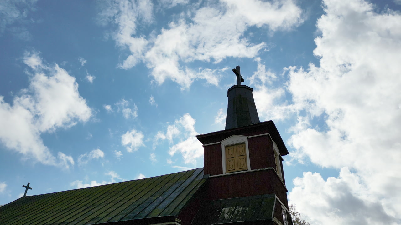A church tower, smooth shot moving clouds in the background.