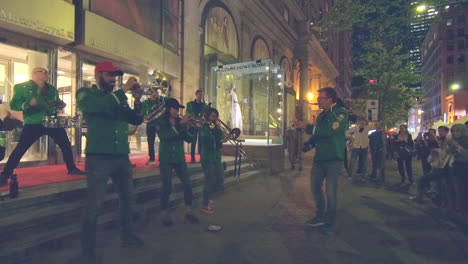 editorial, street event, night summer event, festival, music band playing in street, people watching.