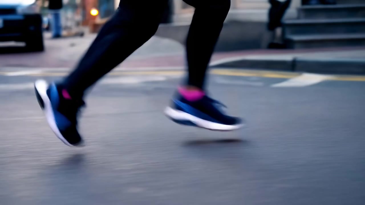 dynamic runner in motion on urban street with blue and black shoes and legs in side view showing active fitness and sports lifestyle period . . . . . . . . . . . . . . . . . . . . . . . . n.