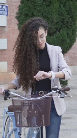 young woman checking time on bike