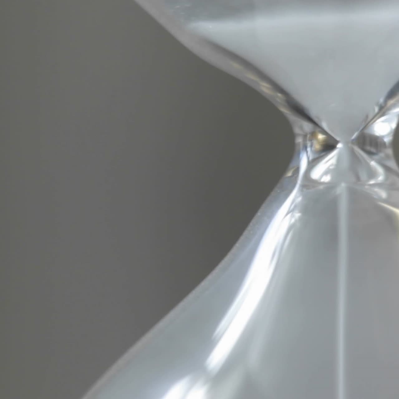 Sand falls through an hour glass