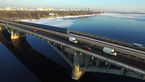 aerial view of car driving on highway bridge