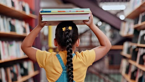 girl carrying books on head in a library