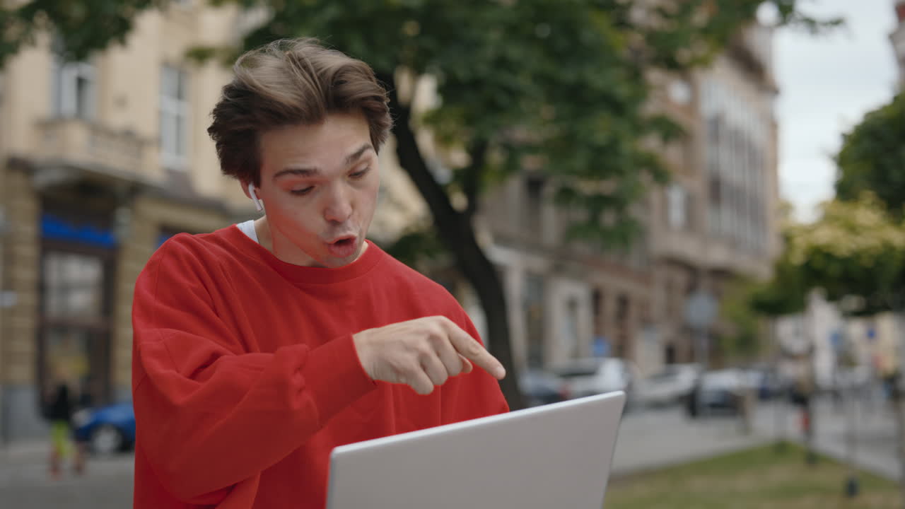 Man using laptop in urban environment