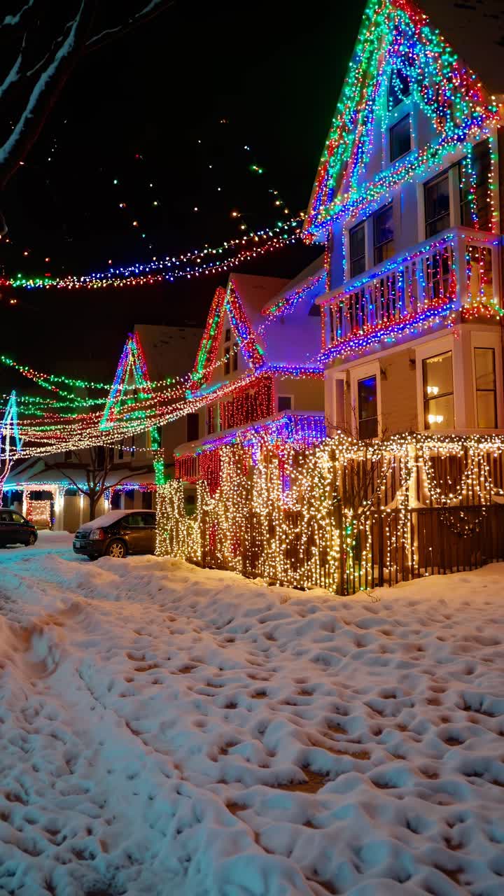 Festive winter scene with houses adorned in colorful lights. Captured from a low angle, perfect