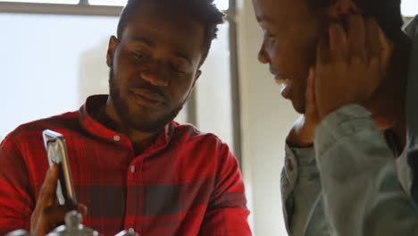 couple interacting with each other while using mobile phone 4k