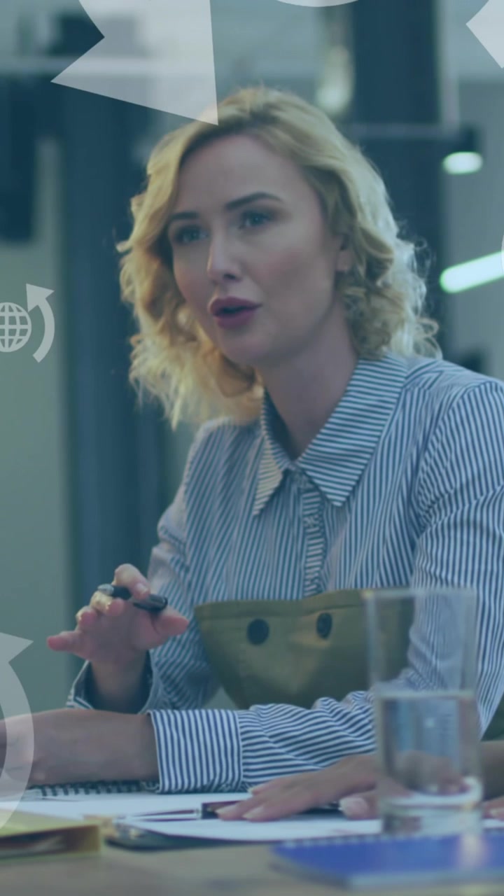 Animation of network of globe icons over business people in office