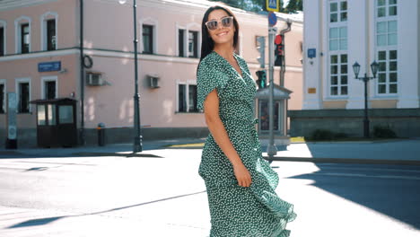 woman in a green dress in a city