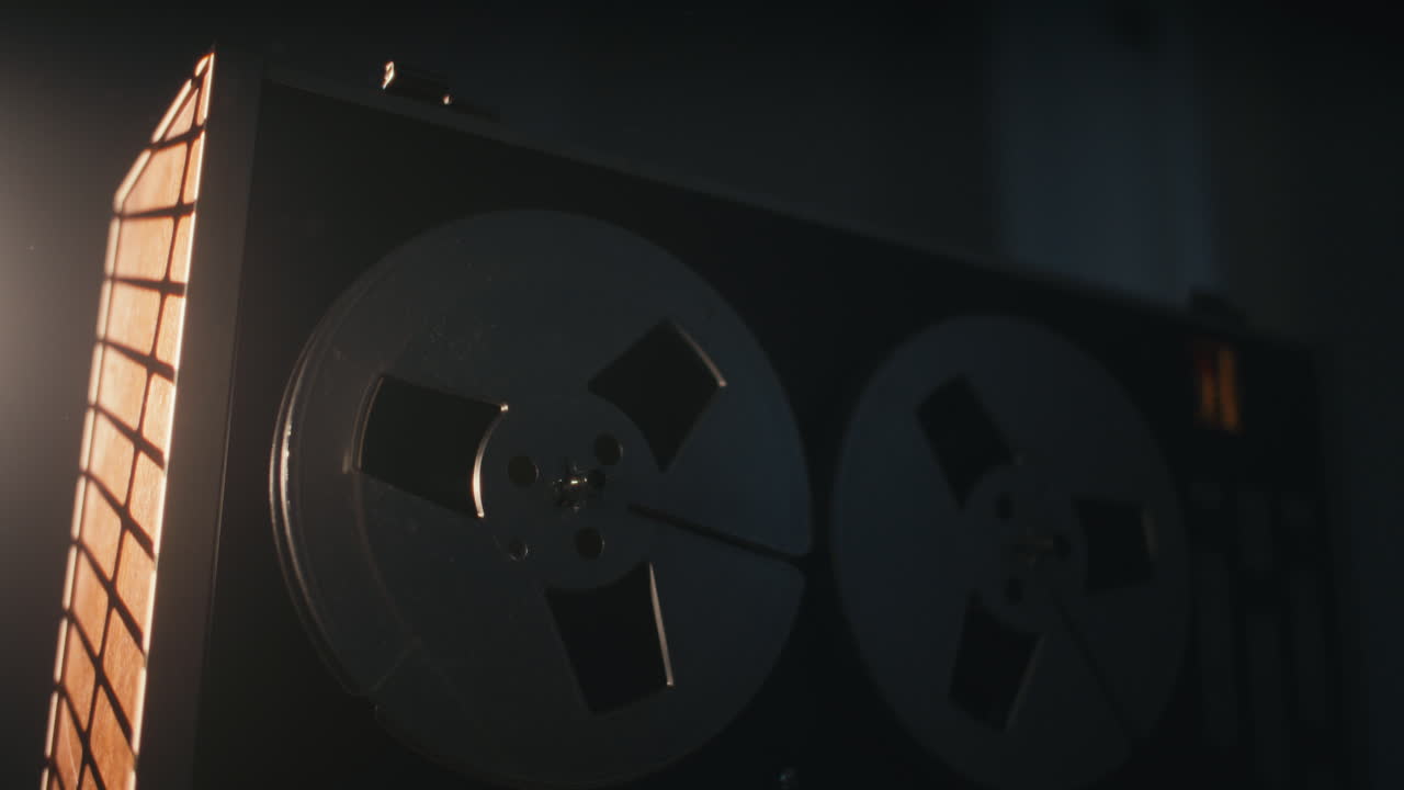 A vintage tape recorder in a red blinking light