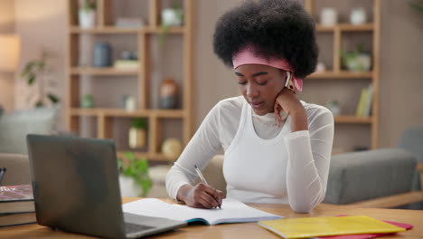 young woman taking notes at her desk