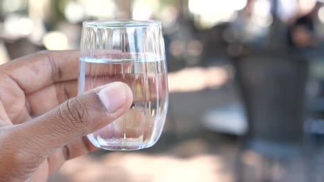 hand holding a shot glass