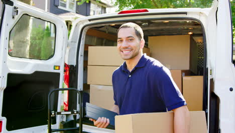 portrait of courier with digital tablet delivering package