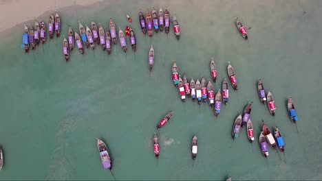 remarkable overhead aerial shot of traditional colourful thai boats docked on a sandy beach