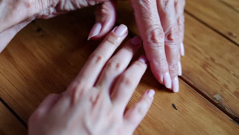 intergenerational connection: young hands touching old hands