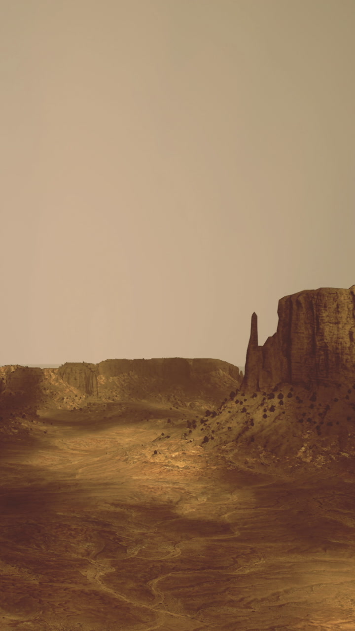 Majestic rock formations rise against a golden desert sky at dusk