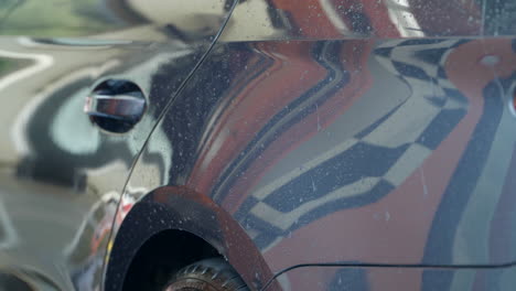 vehicle detail car wash dryer blowing water droplets across bodywork panels