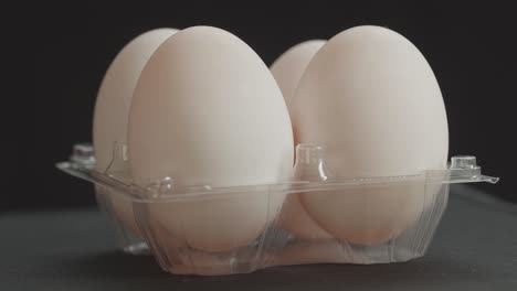 row of fresh white duck eggs in the cells egg storage box rotating in a slow movement.without a doubt, there are a multitude of benefits to eating eggs every day